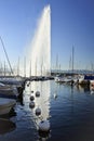 Famous fountain Jet d`Eau in Lake Geneva at twilight.